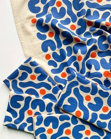 cotton tea towel with blue and orange abstract pattern on a white background