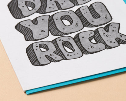 Card with 'Dude, You Rock' text on a beige background