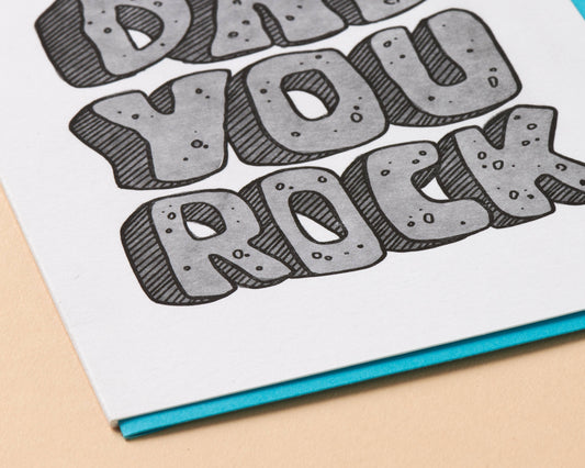 Card with 'Dude, You Rock' text on a beige background