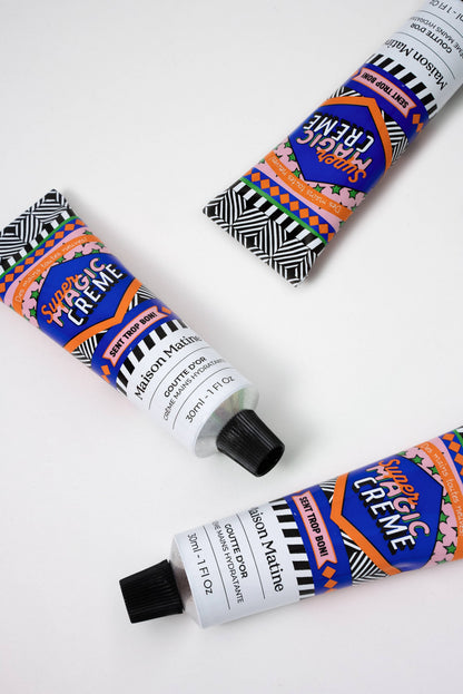 Three tubes of Super Creme Hand Creme by Maison Matine with colorful packaging on a white background