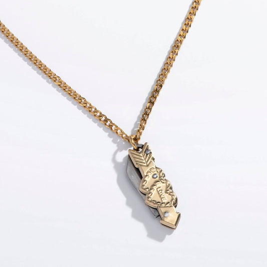 Gold necklace with a decorative LOVE pendant on a light gray background