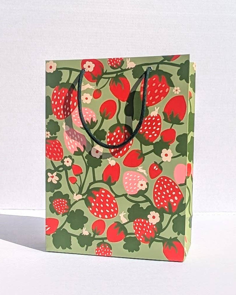 Gift bag with strawberry pattern on a white background