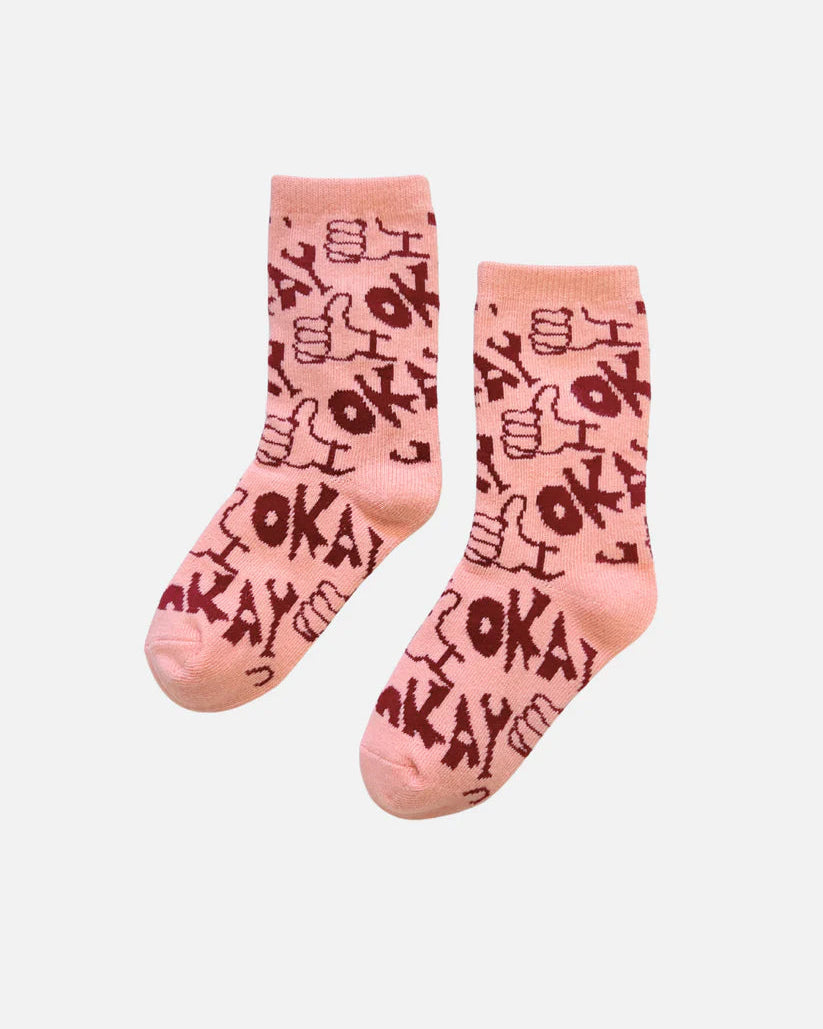 Pink kid socks with black text on a white background