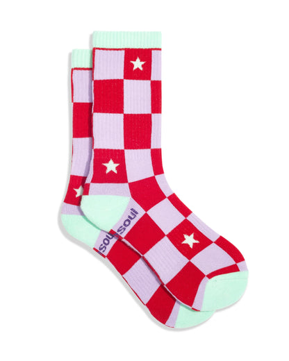 Red and pink checkered socks with star patterns and green accents on a white background