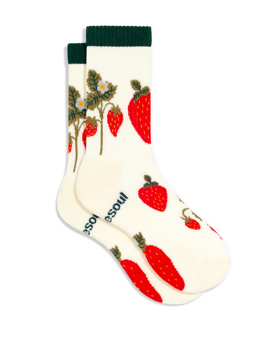 White sock with red strawberry pattern and green accents on a white background